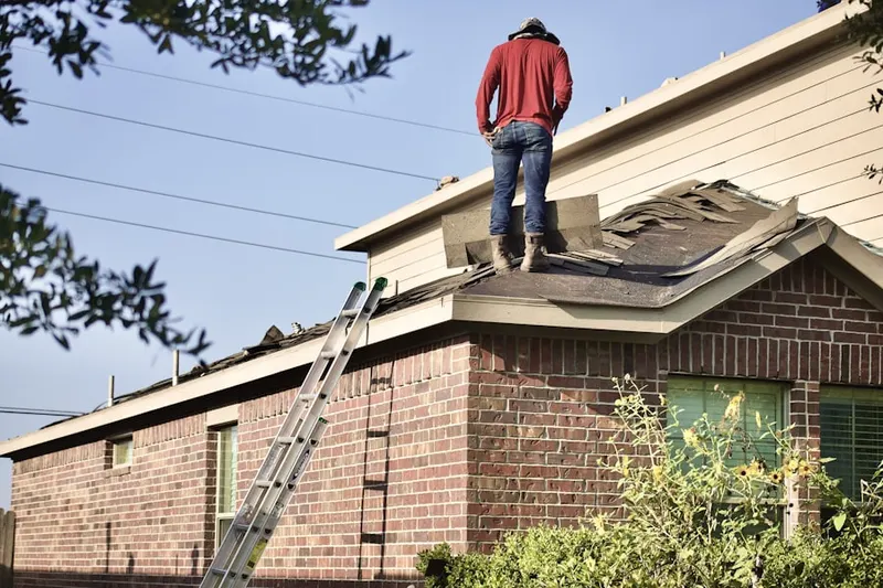 Professional roofer working on a residential roof in San Juan